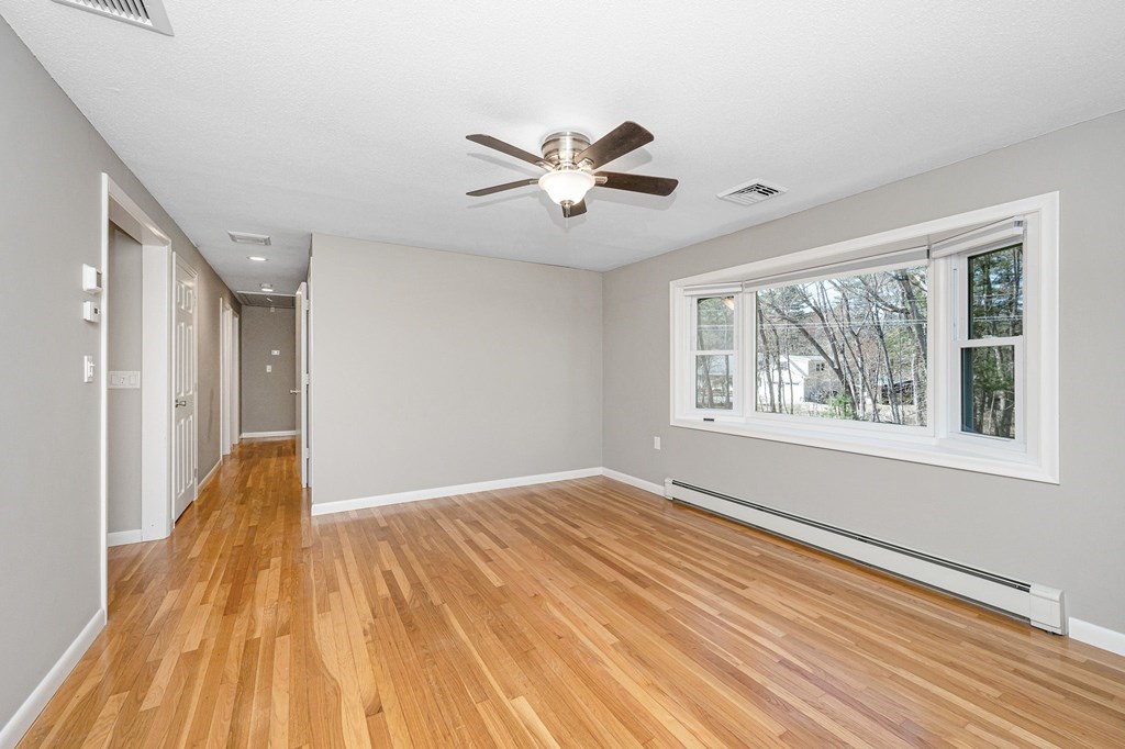 23 Lane Road Pelham, NH 03076 - Photo 5 of 42 a view of empty room with wooden floor and fan