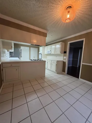 a kitchen with a sink cabinets and window