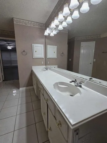 a bathroom with a sink vanity and a mirror
