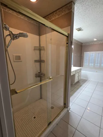 a bathroom with a glass shower door