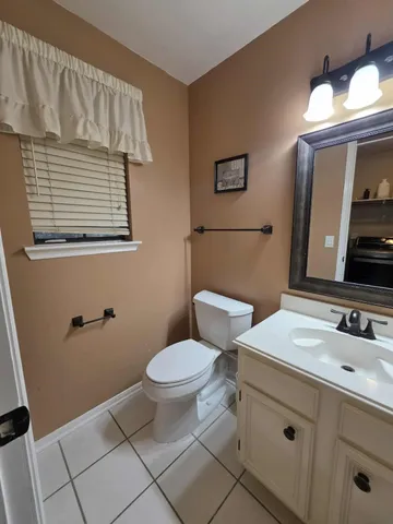 a bathroom with a sink toilet and mirror