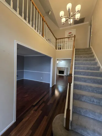 a view of entryway and hall with wooden floor