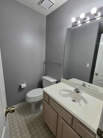a bathroom with a sink toilet and a mirror
