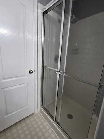 a bathroom with a glass door shower