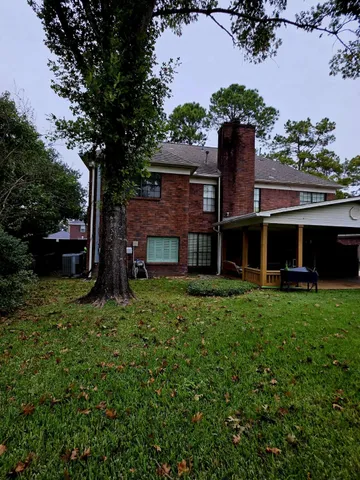 a view of a backyard with large trees