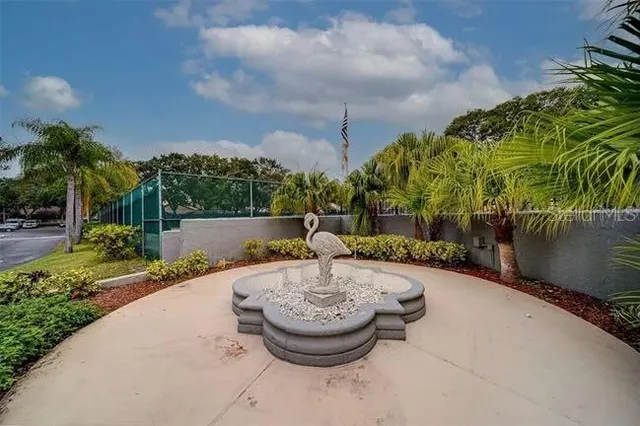 a view of kitchen with granite countertop cabinets and refrigerator