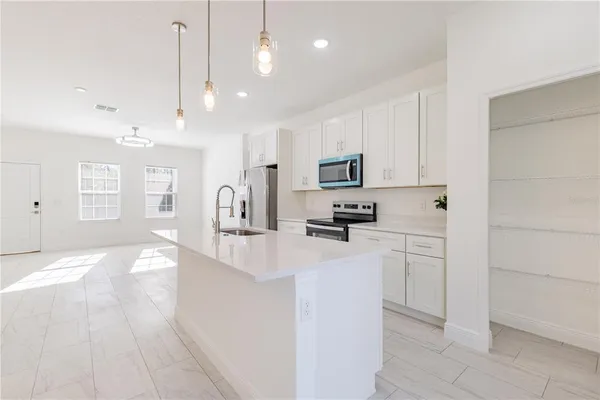 a kitchen with refrigerator and sink