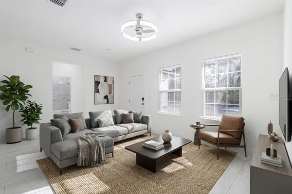 a large white kitchen with lots of counter space a sink appliances and cabinets