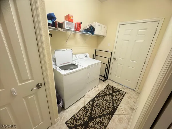 a utility room with sink dryer and washer