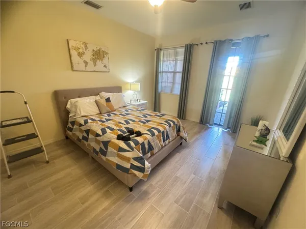 a bedroom with a bed and window
