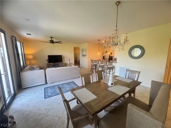 a view of a dining room with furniture and a chandelier