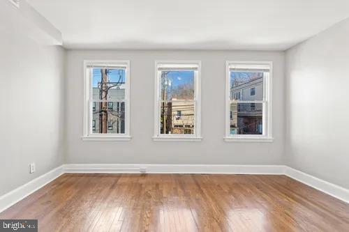 3742 12th Street Northeast, Unit 2 Washington, DC 20017 - Photo 2 of 8 an empty room with wooden floor and windows