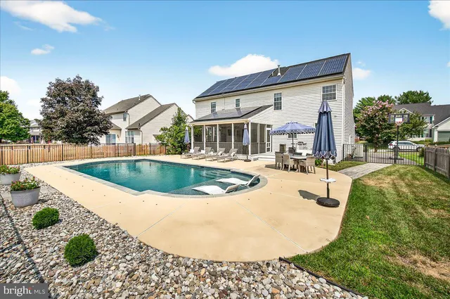 a view of a patio with a dining table and chairs
