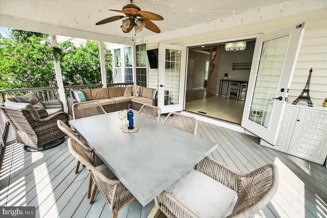 a living room with couches and a flat screen tv