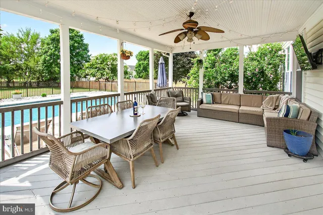 a view of a balcony dining area with furniture window and wooden floor