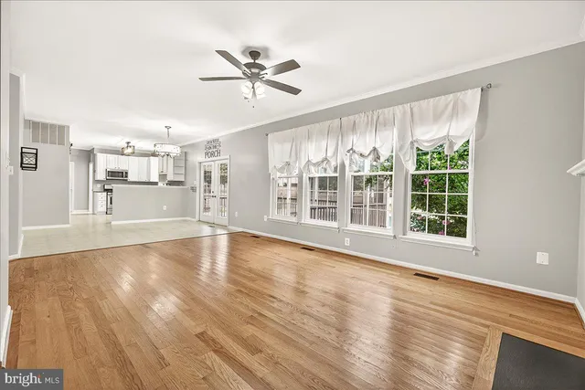 a kitchen with granite countertop white cabinets and stainless steel appliances