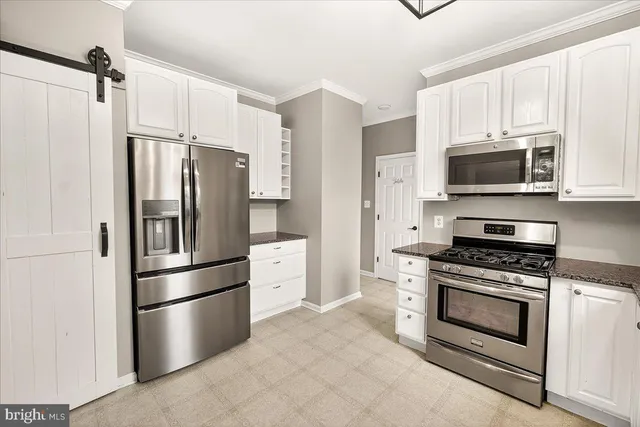an empty room with wooden floor and ceiling fan
