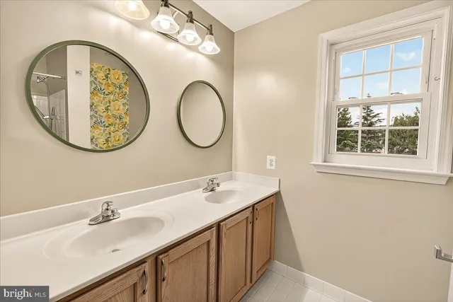 a view of a room with a ceiling fan and a window