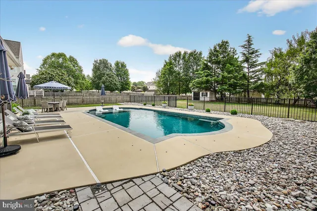 a view of a dining room with furniture wooden floor and chandelier