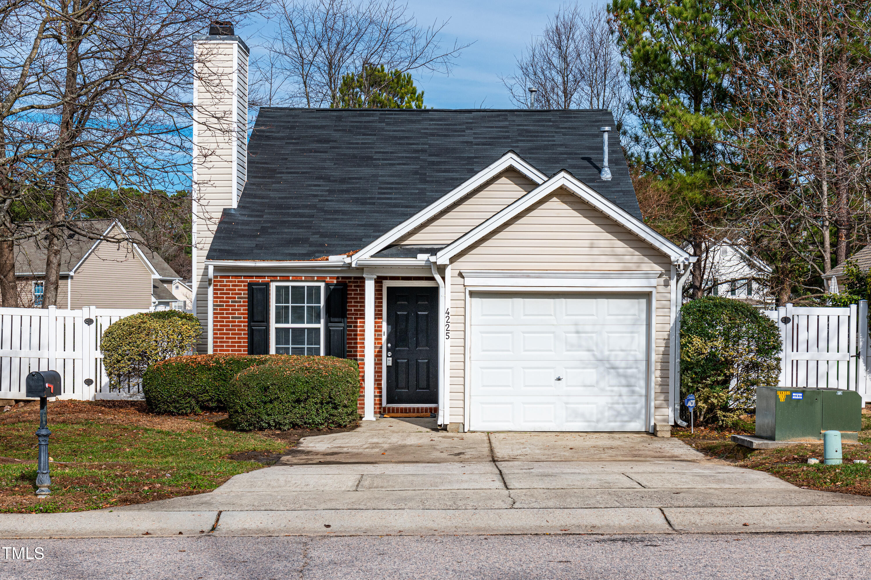 a front view of a house with a garden and plants