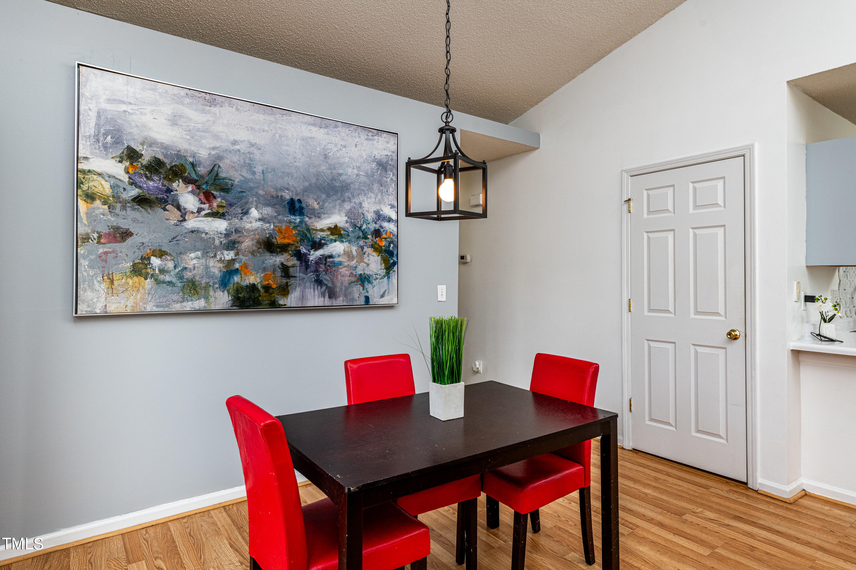 4225 Lake Woodard Drive Raleigh, NC 27604 - Photo 14 of 27 a view of a dining room with furniture a chandelier and wooden floor