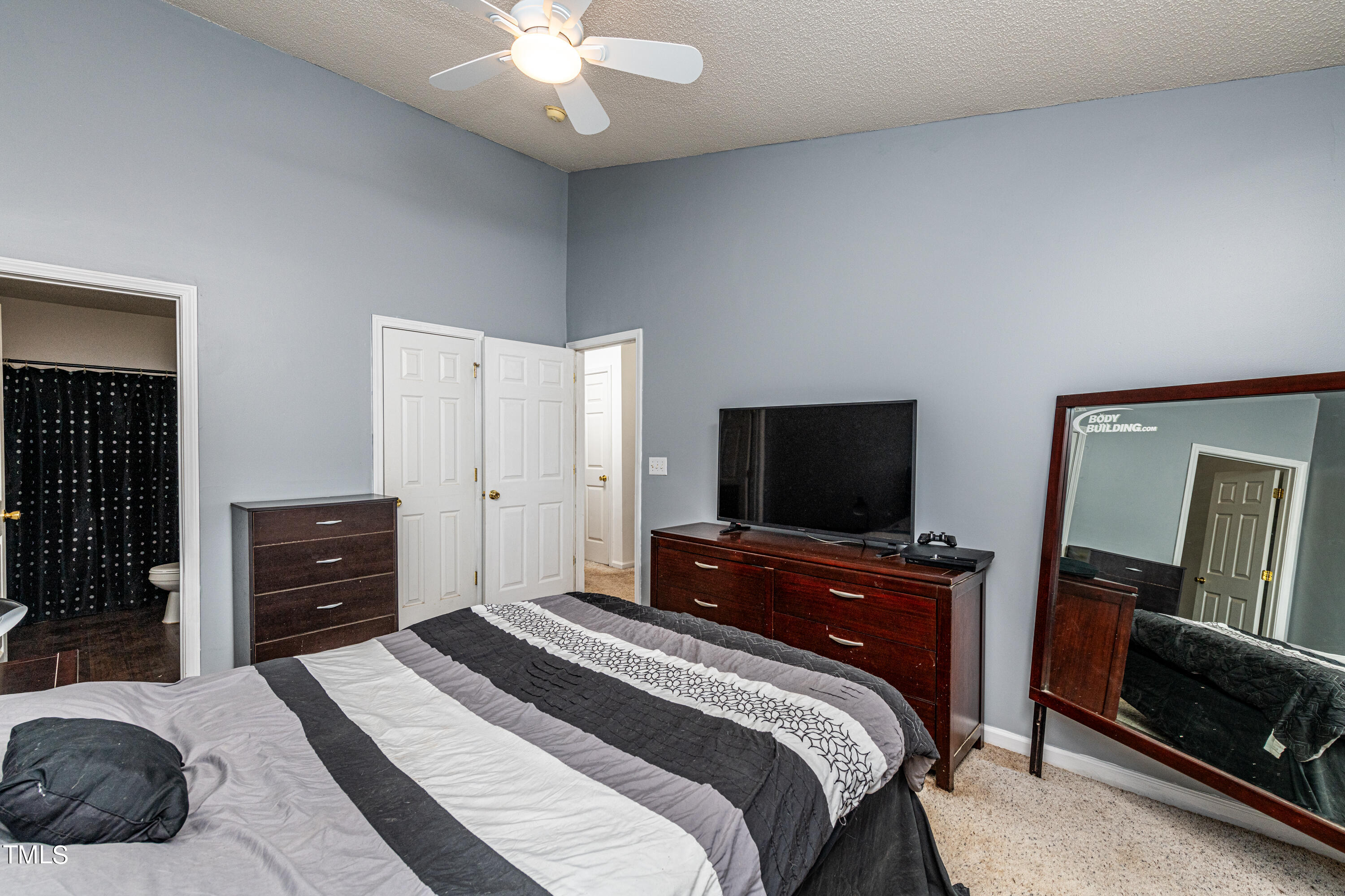 4225 Lake Woodard Drive Raleigh, NC 27604 - Photo 16 of 27 a bedroom with a bed and a flat screen tv