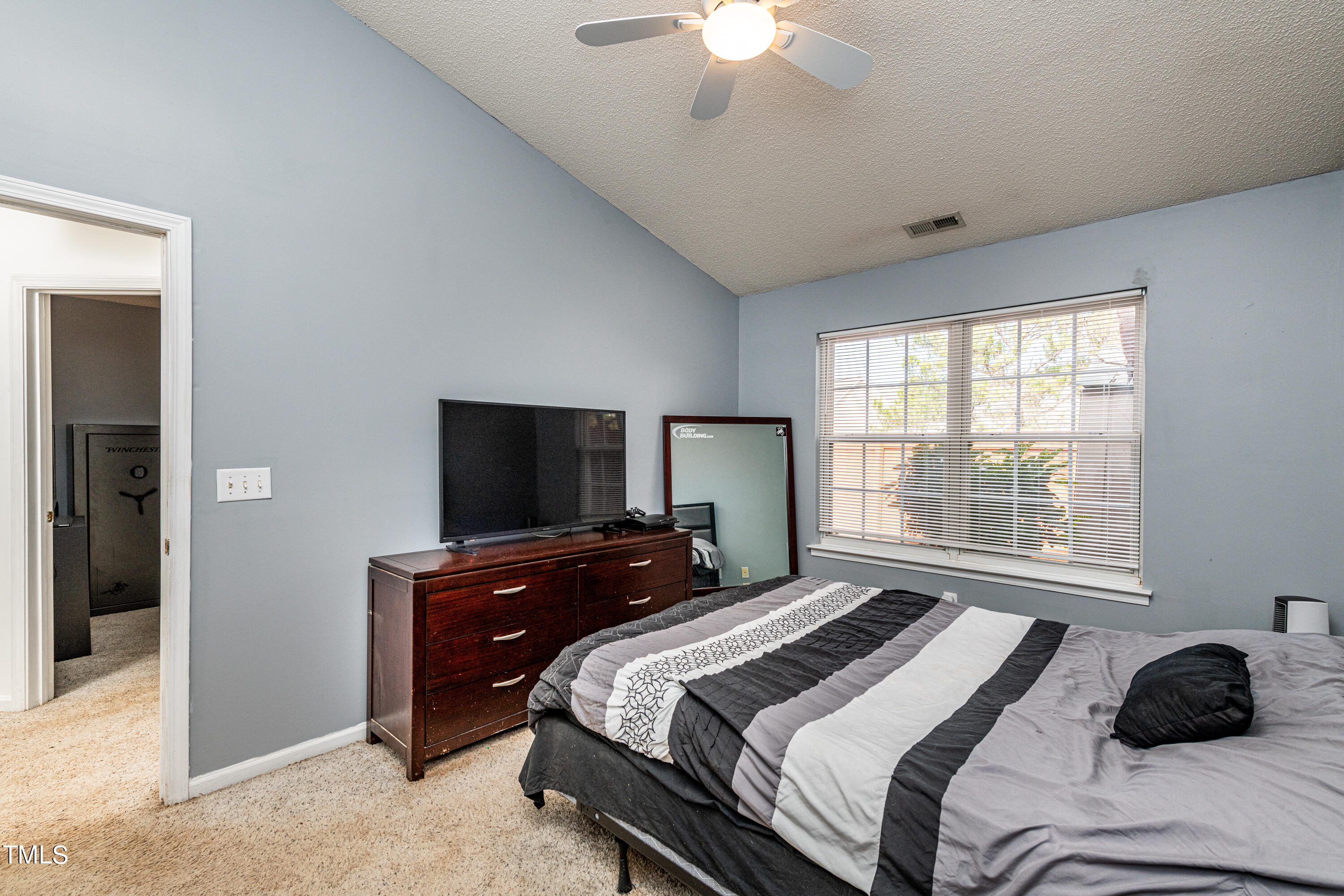 4225 Lake Woodard Drive Raleigh, NC 27604 - Photo 17 of 27 a bedroom with a bed and a flat tv screen on dresser