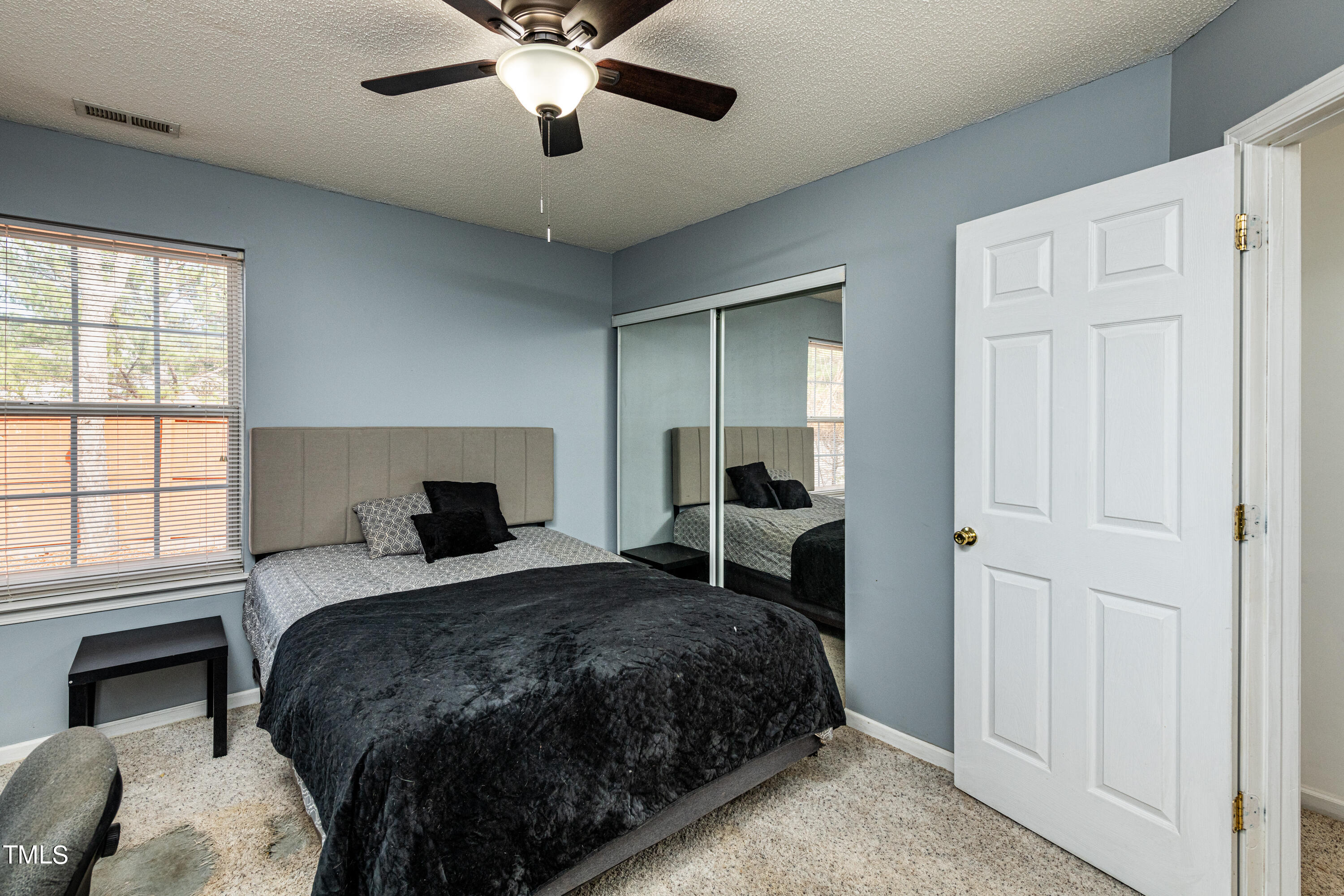 4225 Lake Woodard Drive Raleigh, NC 27604 - Photo 20 of 27 a bedroom with a large bed and a window