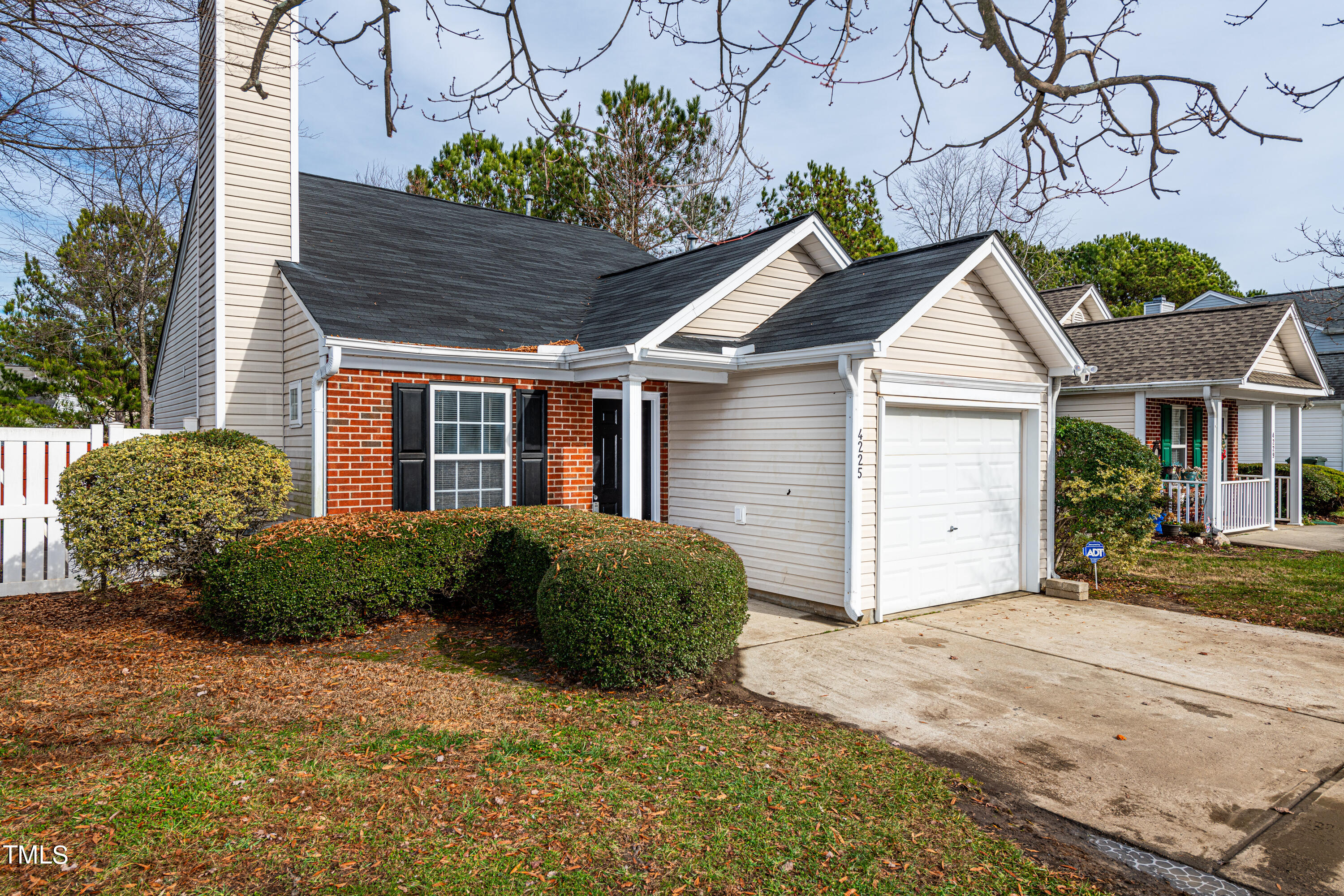 4225 Lake Woodard Drive Raleigh, NC 27604 - Photo 3 of 27 a view of a house with a small yard and plants