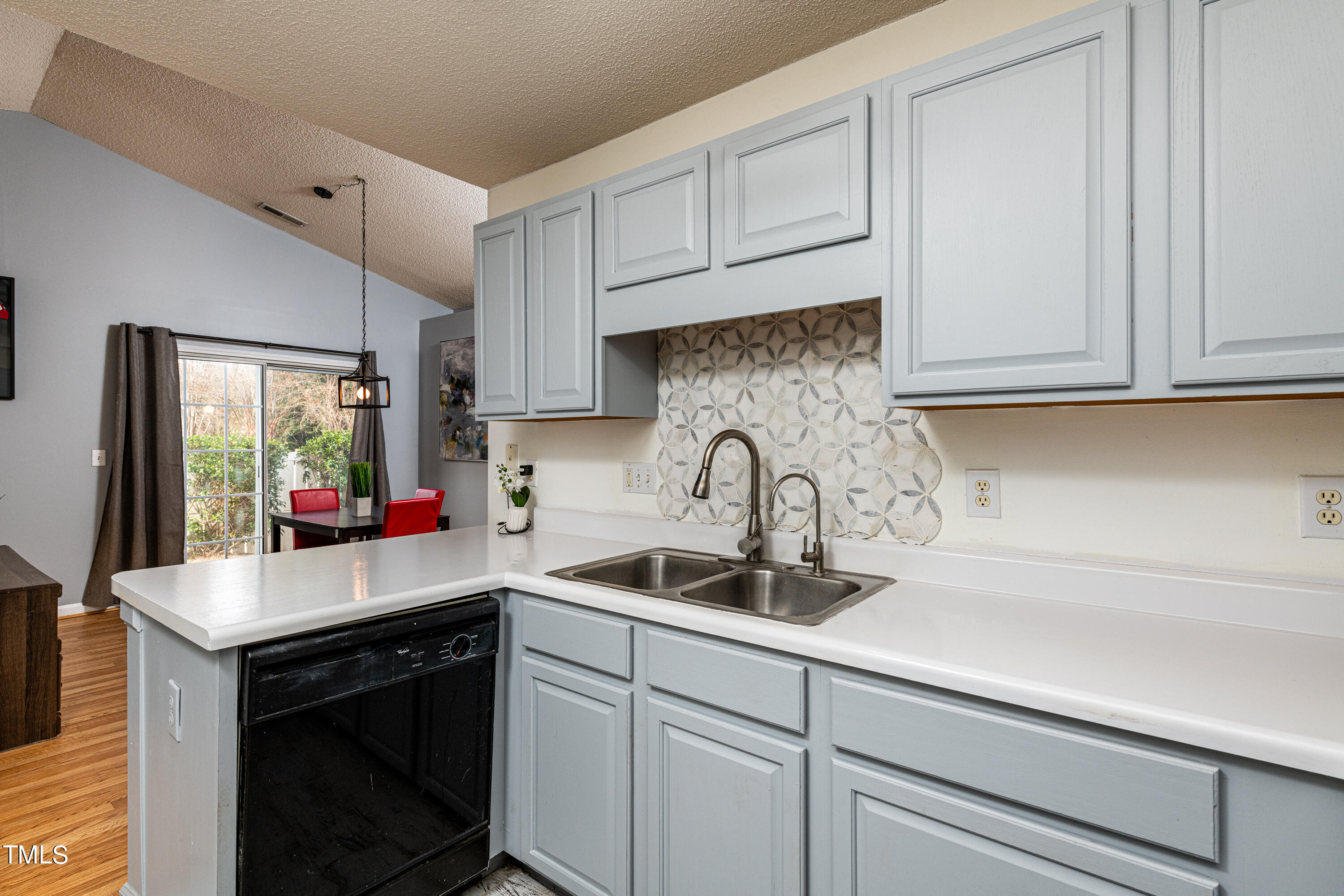 4225 Lake Woodard Drive Raleigh, NC 27604 - Photo 5 of 27 a kitchen with stainless steel appliances granite countertop a sink and cabinets