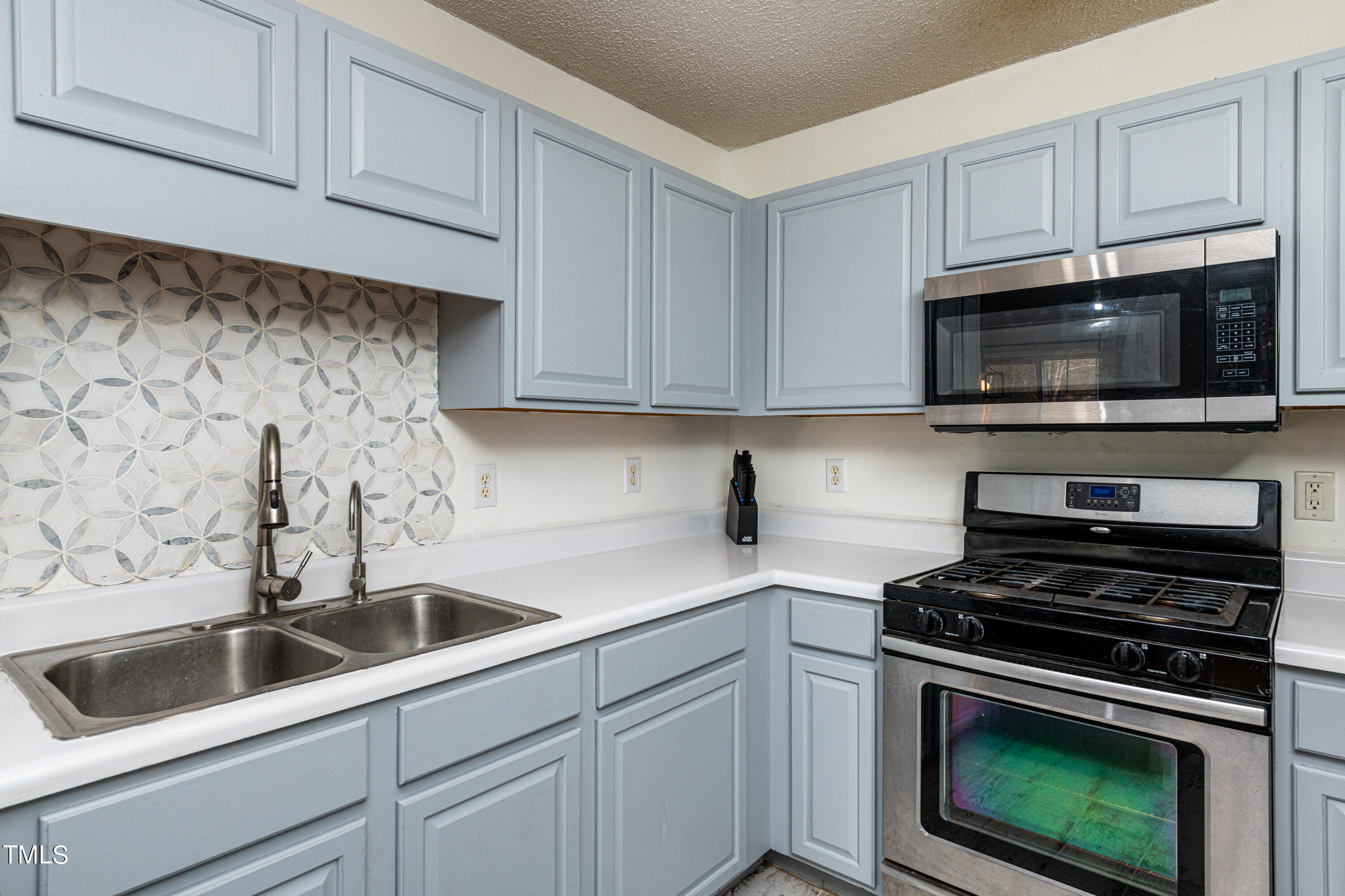 4225 Lake Woodard Drive Raleigh, NC 27604 - Photo 6 of 27 a kitchen with cabinets stainless steel appliances and a sink