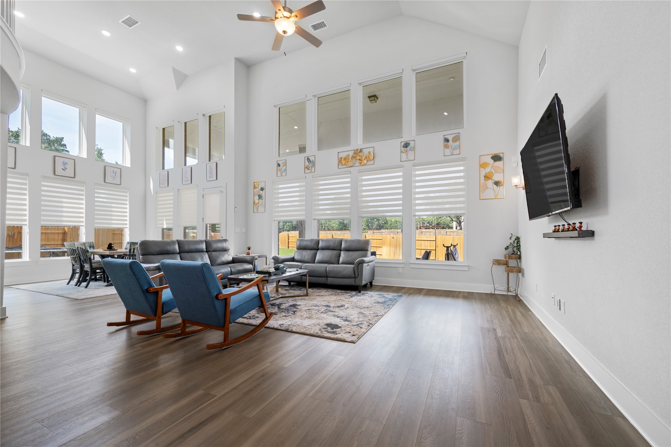 105 Autumn Oak Way Georgetown, TX 78628 - Photo 13 of 40 Spacious living area featuring high vaulted ceilings, expansive windows with blinds, wood-finish flooring, and recessed lighting