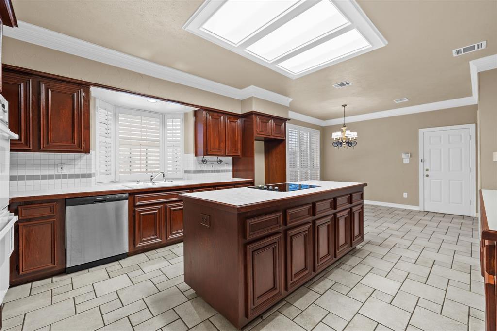 8049 Sunscape Lane Fort Worth, TX 76123 - Photo 13 of 37 a kitchen with stainless steel appliances granite countertop a stove a sink and a microwave