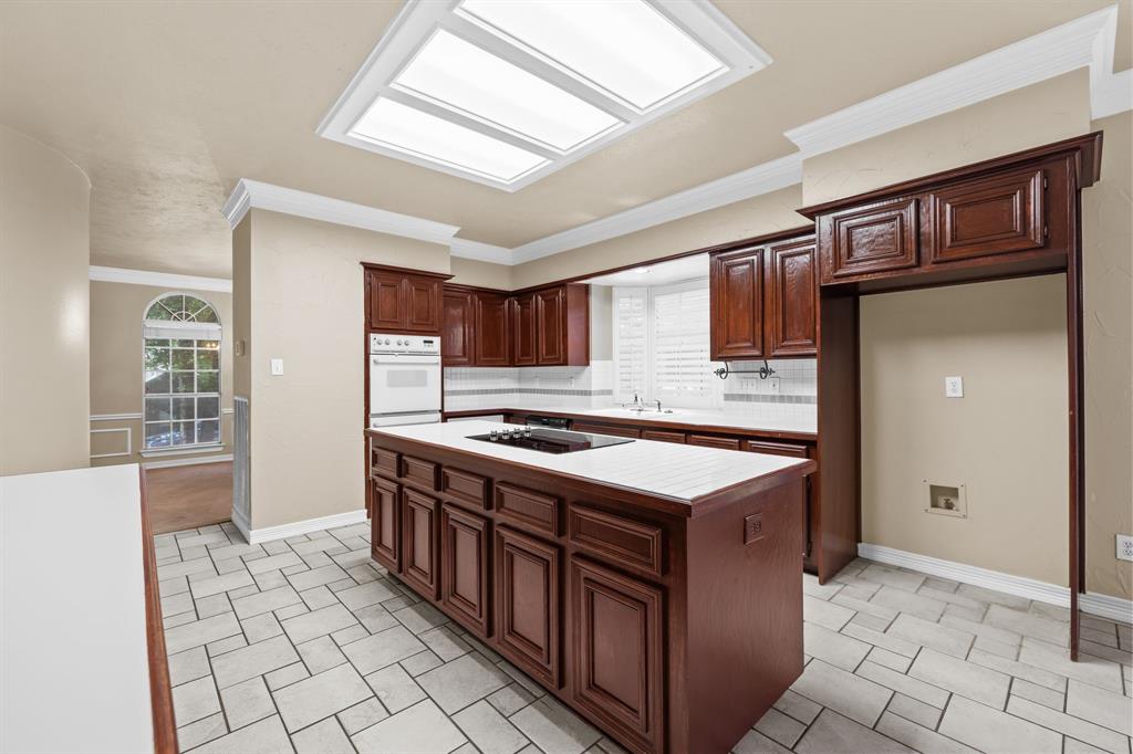 8049 Sunscape Lane Fort Worth, TX 76123 - Photo 15 of 37 a kitchen with stainless steel appliances granite countertop a stove a refrigerator and a cabinets