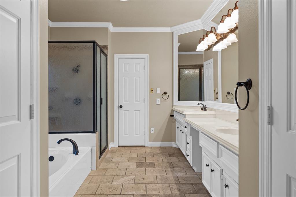 8049 Sunscape Lane Fort Worth, TX 76123 - Photo 20 of 37 a spacious bathroom with a granite countertop sink a toilet a mirror and shower