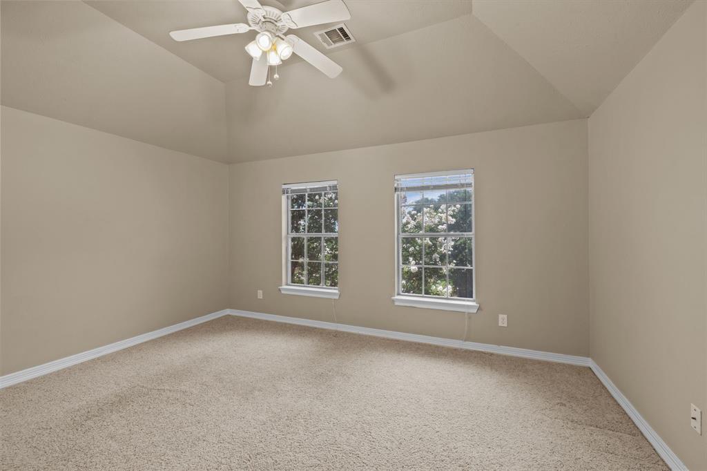8049 Sunscape Lane Fort Worth, TX 76123 - Photo 24 of 37 an empty room with chandelier fan and windows
