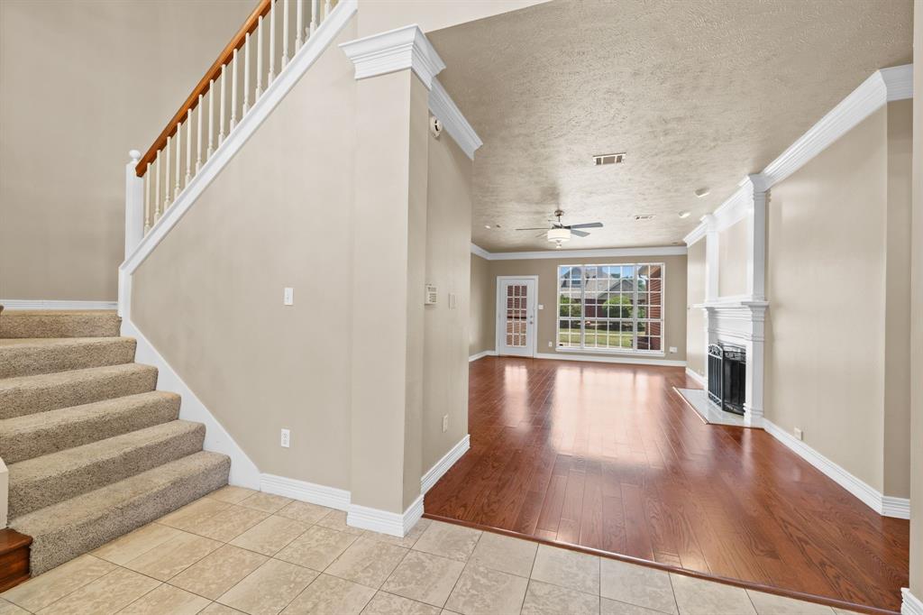8049 Sunscape Lane Fort Worth, TX 76123 - Photo 3 of 37 a view of an entryway with wooden floor