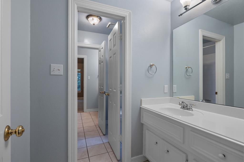 8049 Sunscape Lane Fort Worth, TX 76123 - Photo 31 of 37 a bathroom with a sink and a mirror