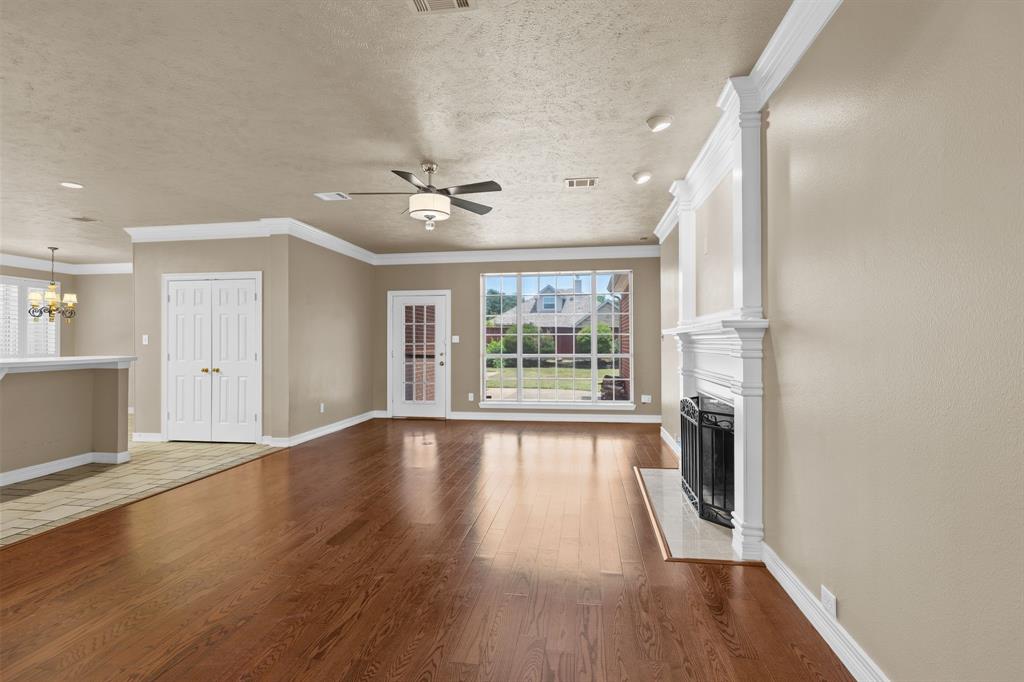 8049 Sunscape Lane Fort Worth, TX 76123 - Photo 8 of 37 a view of an empty room with a window and wooden floor