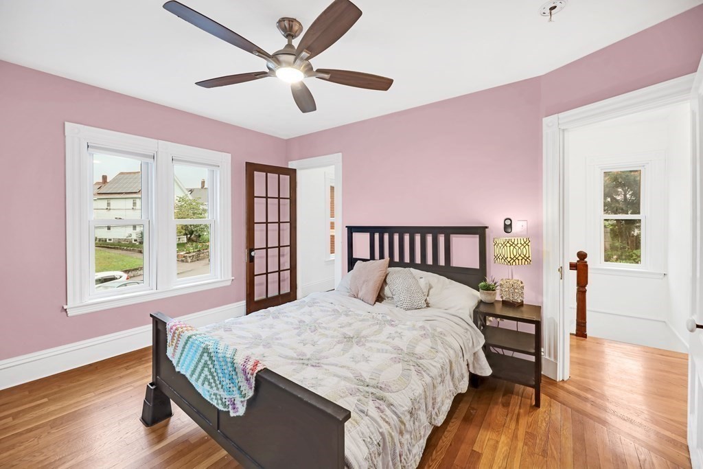 79 Harvard Avenue Boston, MA 02136 - Photo 16 of 33 a bedroom with a large bed and a chandelier