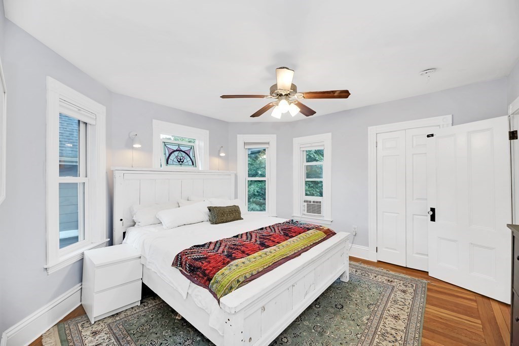 79 Harvard Avenue Boston, MA 02136 - Photo 24 of 33 a bedroom with a bed and a chandelier