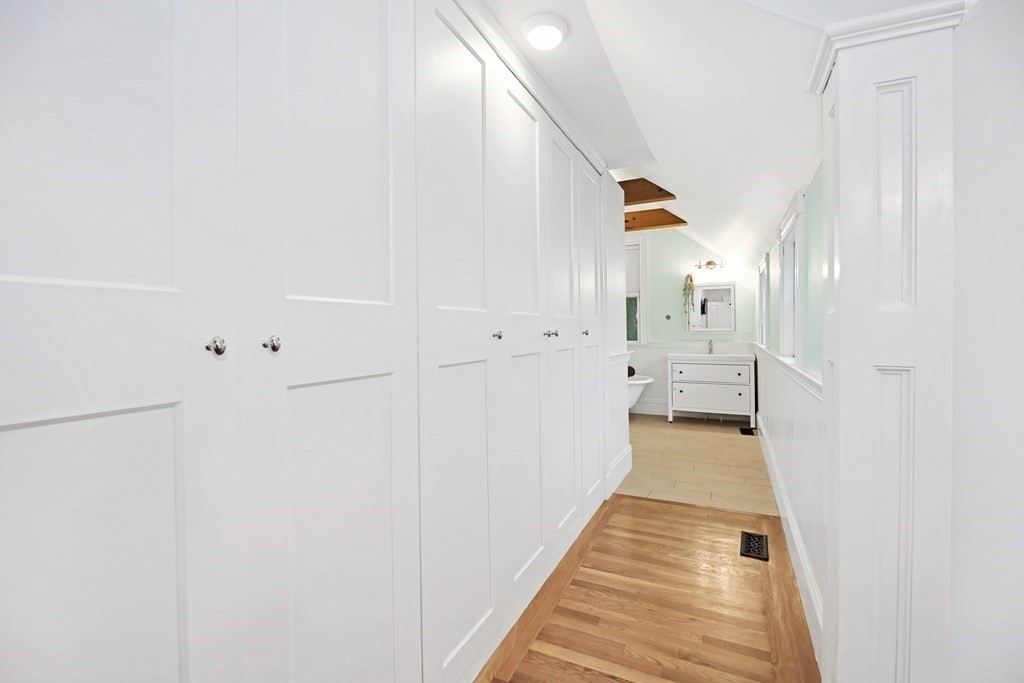 79 Harvard Avenue Boston, MA 02136 - Photo 25 of 33 a view of a hallway with white cabinets and wooden floor