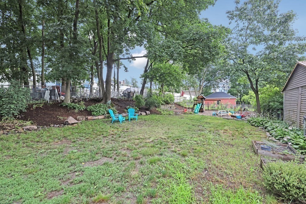 79 Harvard Avenue Boston, MA 02136 - Photo 33 of 33 a backyard of a house with outdoor seating and trees
