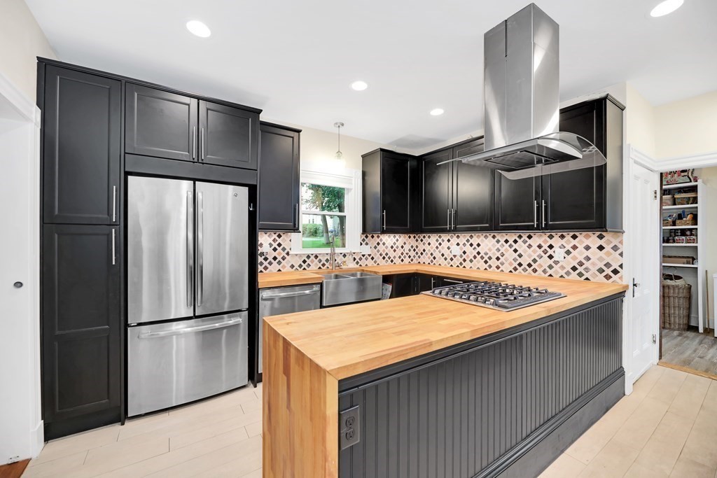 79 Harvard Avenue Boston, MA 02136 - Photo 4 of 33 a kitchen with stainless steel appliances kitchen island granite countertop a refrigerator and a sink