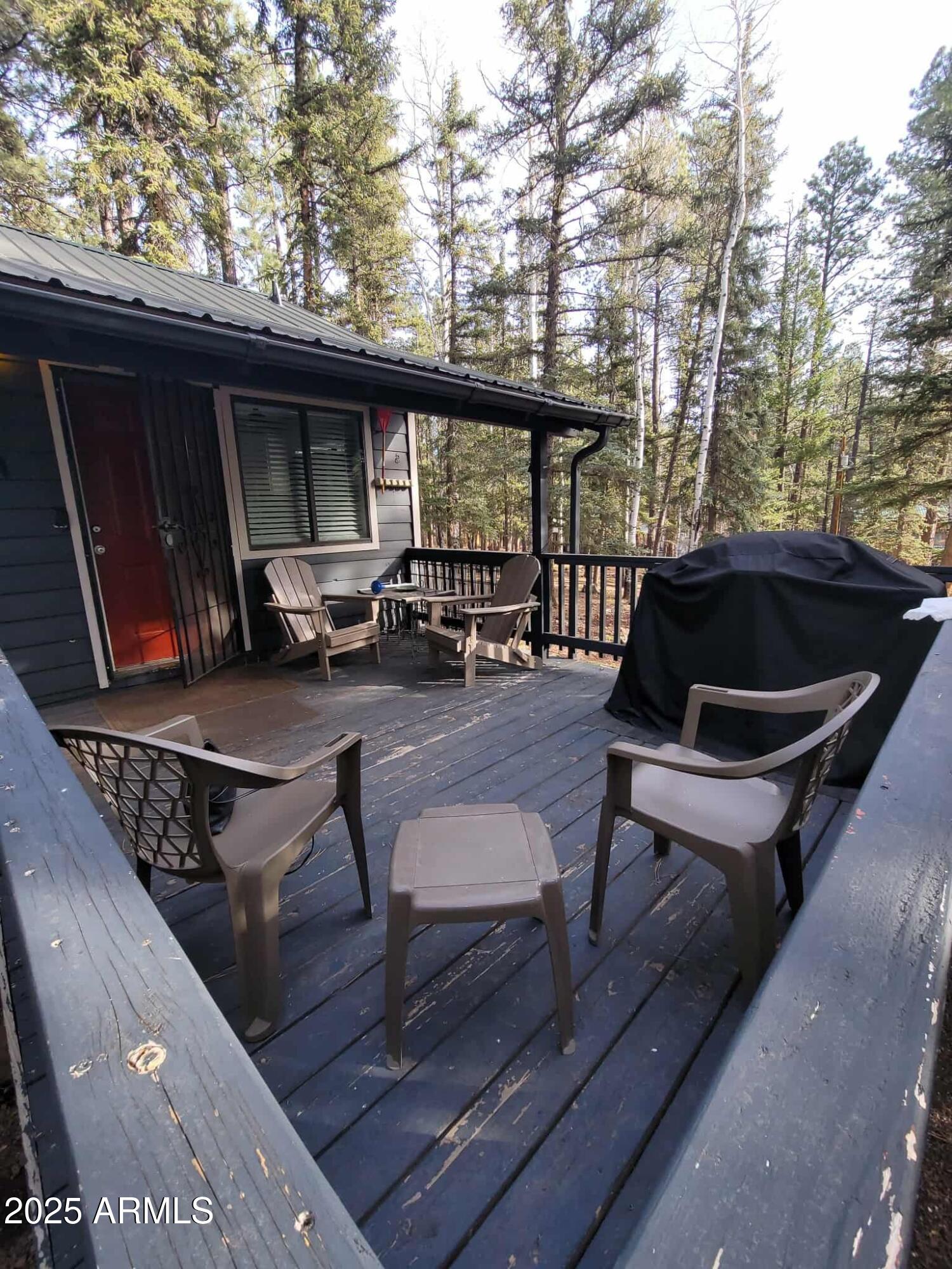 6 County Road, Unit 4 Eagar, AZ 85925 - Photo 2 of 26 a view of patio with lawn chairs and wooden fence