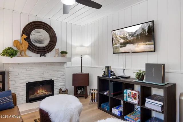 a living room with furniture a rug and a fireplace