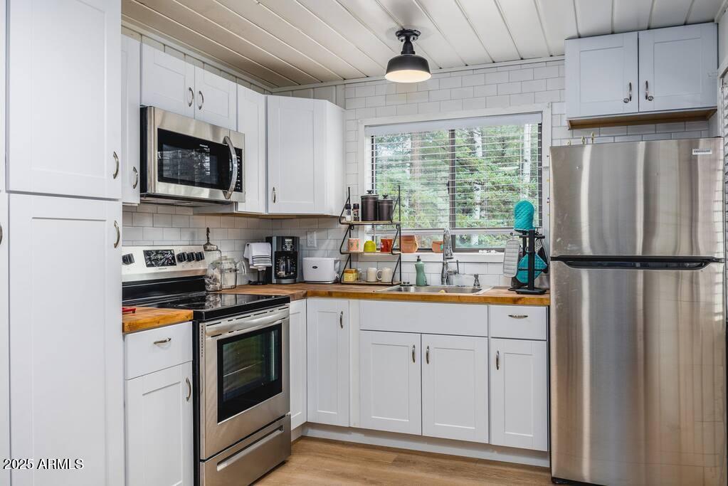 6 County Road, Unit 4 Eagar, AZ 85925 - Photo 7 of 26 a kitchen with stainless steel appliances granite countertop a refrigerator a stove a sink and a microwave