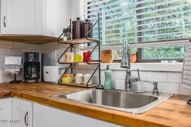 a kitchen with stainless steel appliances granite countertop a sink and a wooden floors