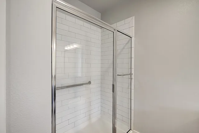 a bathroom with a glass shower door