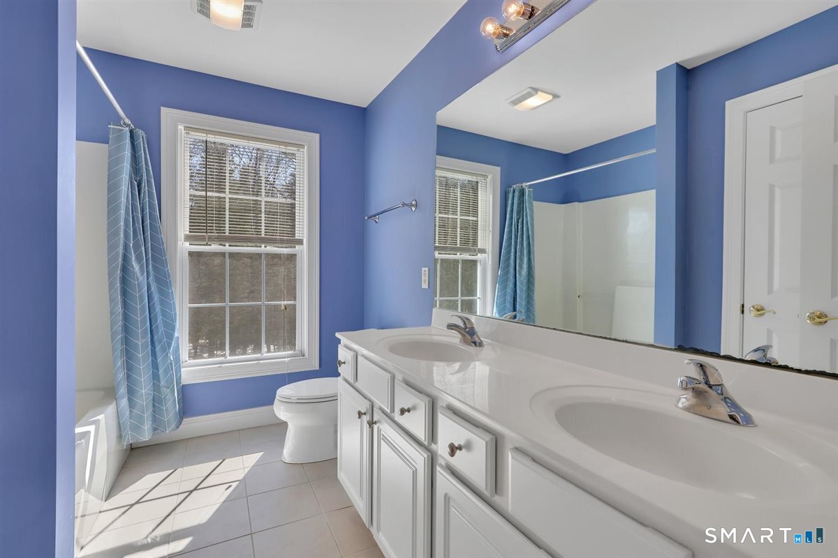 25 Fenwick Drive Avon, CT 06001 - Photo 31 of 40 a bathroom with a double vanity sink toilet and a mirror